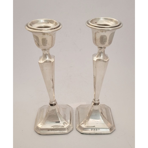 159 - TWO EARLY 20TH CENTURY ART DECO SILVER TAPERED CANDLESTICKS, with octagonal shaped base and column b... 