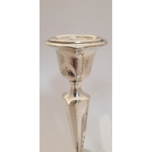 159 - TWO EARLY 20TH CENTURY ART DECO SILVER TAPERED CANDLESTICKS, with octagonal shaped base and column b... 