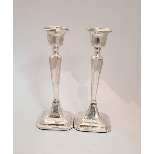 159 - TWO EARLY 20TH CENTURY ART DECO SILVER TAPERED CANDLESTICKS, with octagonal shaped base and column b... 