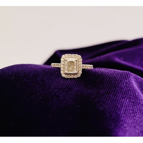 161 - A GOOD PLATINUM DIAMOND HALO RING, with a radiant cut diamond to the centre, surrounded by a frame o... 