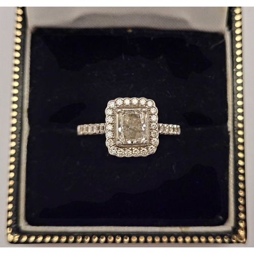 161 - A GOOD PLATINUM DIAMOND HALO RING, with a radiant cut diamond to the centre, surrounded by a frame o... 