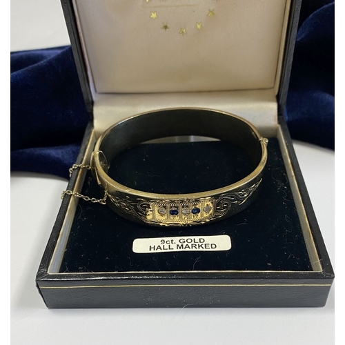 164 - A BEAUTIFUL 9CT GOLD PLATED GEMSET BANGLE BRACELET, with two round cut blue gemstones and three roun... 