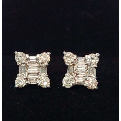 17 - A STRIKING PAIR OF 18CT WHITE GOLD DIAMOND STUD EARRINGS, with baguette cut diamonds to centre surro... 