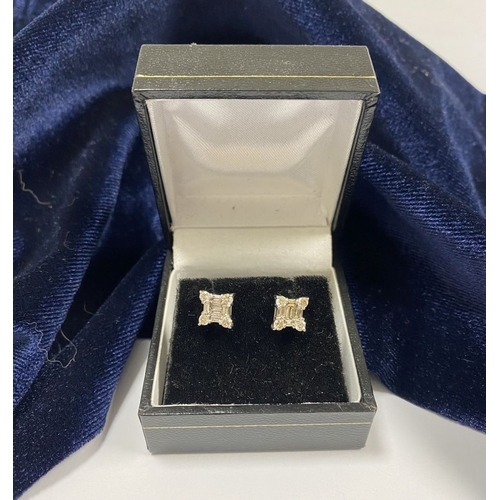 17 - A STRIKING PAIR OF 18CT WHITE GOLD DIAMOND STUD EARRINGS, with baguette cut diamonds to centre surro... 