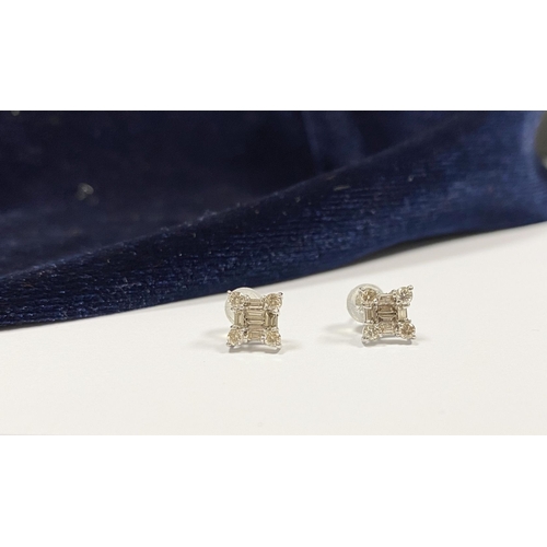 17 - A STRIKING PAIR OF 18CT WHITE GOLD DIAMOND STUD EARRINGS, with baguette cut diamonds to centre surro... 