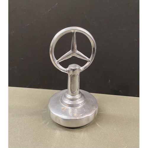 180 - A CHROME TONE MERCEDES DESK ORNAMENT, dimensions: 23cm high approx.