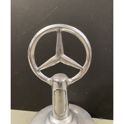 180 - A CHROME TONE MERCEDES DESK ORNAMENT, dimensions: 23cm high approx.