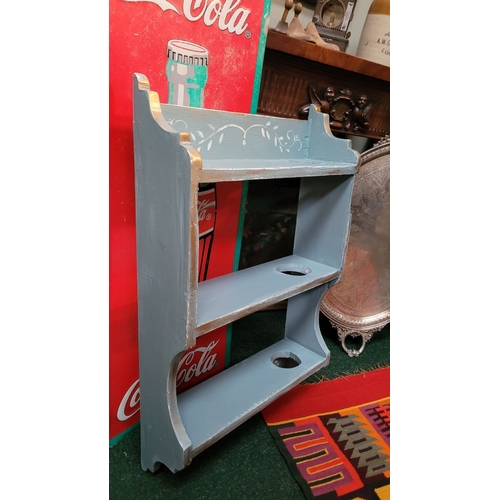 186 - A VINTAGE HAND PAINTED THREE TIER WALL SHELF, with pierced hole on each shelf; possibly for holding ... 