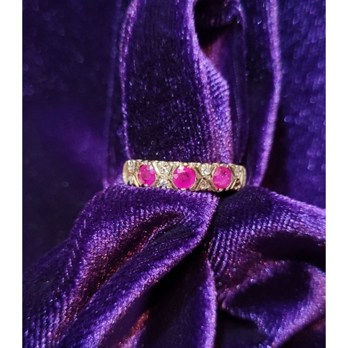 198 - AN ANTIQUE 9CT YELLOW GOLD 11 STONE RUBY & DIAMOND RING, with three round cut rubies and two diamond... 