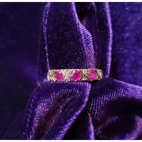 198 - AN ANTIQUE 9CT YELLOW GOLD 11 STONE RUBY & DIAMOND RING, with three round cut rubies and two diamond... 