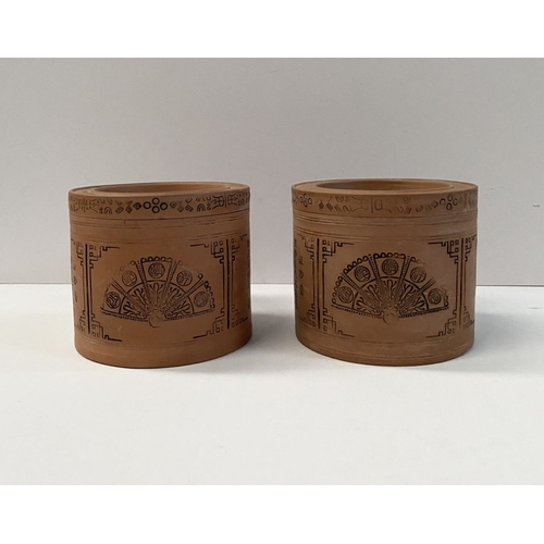 199 - A PAIR OF CHINESE RED CLAY CANNISTERS, cylindrical form, the sides decorated with panels depicting f... 