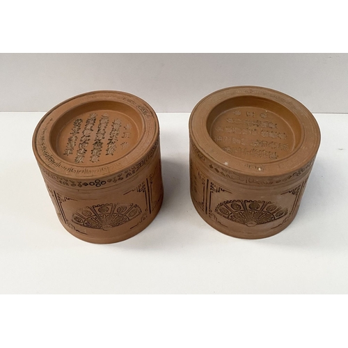 199 - A PAIR OF CHINESE RED CLAY CANNISTERS, cylindrical form, the sides decorated with panels depicting f... 