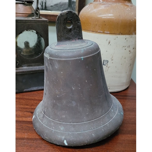 202 - AN ANTIQUE HAND FORGED HEAVY BRASS BELL, with clapper attached, lovely sound to it. Dimensions: 22.5... 