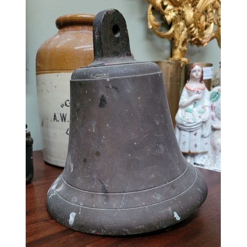 202 - AN ANTIQUE HAND FORGED HEAVY BRASS BELL, with clapper attached, lovely sound to it. Dimensions: 22.5... 