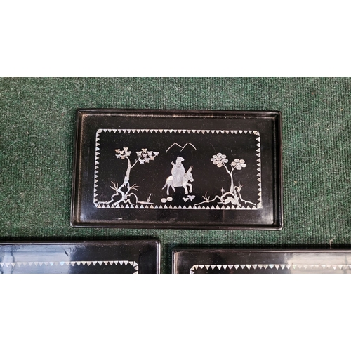 207 - A SET OF FIVE VINTAGE LACQUER & MOTHER OF PEARL INLAID TRAYS of graduating sizes, each depicting fig... 