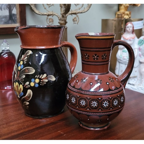 209 - TWO EARTHENWARE HAND PAINTED & GLAZED JUGS, (i) A lovely brown earthenware jug, with floral decorati... 