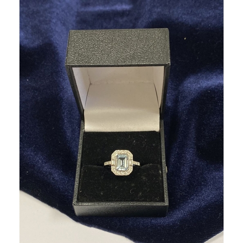 21 - AN 18CT WHITE GOLD AQUAMARINE & DIAMOND RING, with central emerald cut aquamarine, weight: 1.12cts, ... 