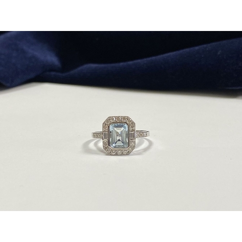 21 - AN 18CT WHITE GOLD AQUAMARINE & DIAMOND RING, with central emerald cut aquamarine, weight: 1.12cts, ... 