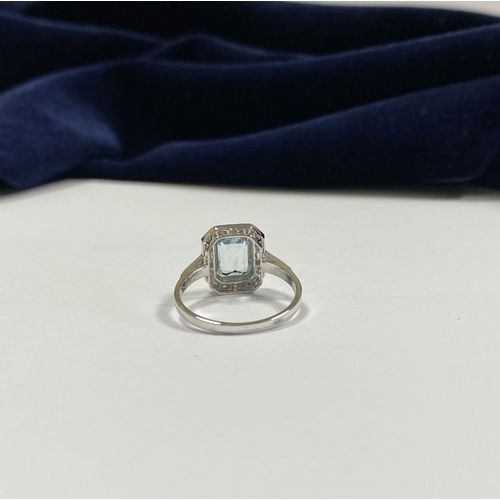 21 - AN 18CT WHITE GOLD AQUAMARINE & DIAMOND RING, with central emerald cut aquamarine, weight: 1.12cts, ... 