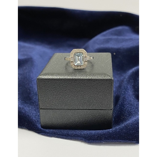 21 - AN 18CT WHITE GOLD AQUAMARINE & DIAMOND RING, with central emerald cut aquamarine, weight: 1.12cts, ... 