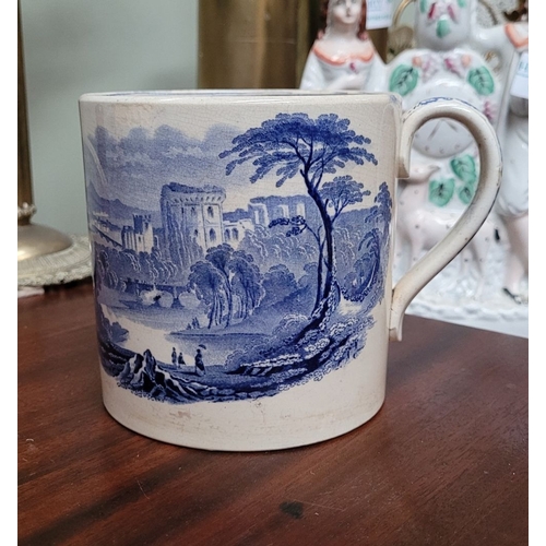 210 - A LARGE ANTIQUE BLUE & WHITE MUG, decorated with landscape scenes to the outside, and a band of flor... 