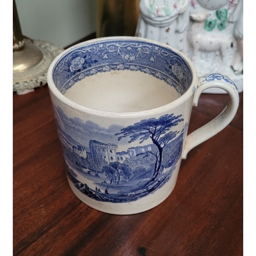 210 - A LARGE ANTIQUE BLUE & WHITE MUG, decorated with landscape scenes to the outside, and a band of flor... 