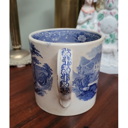 210 - A LARGE ANTIQUE BLUE & WHITE MUG, decorated with landscape scenes to the outside, and a band of flor... 