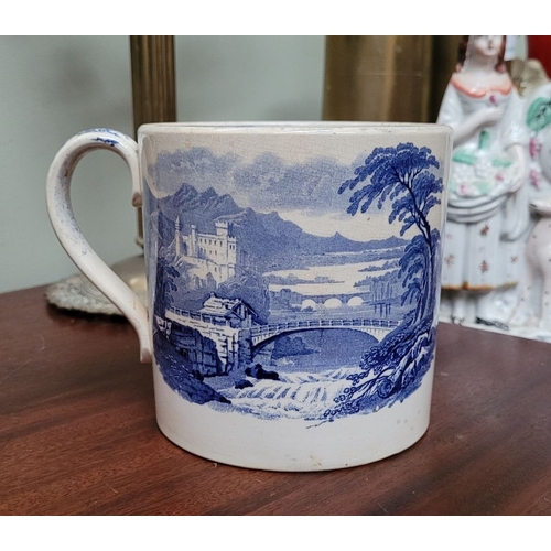 210 - A LARGE ANTIQUE BLUE & WHITE MUG, decorated with landscape scenes to the outside, and a band of flor... 