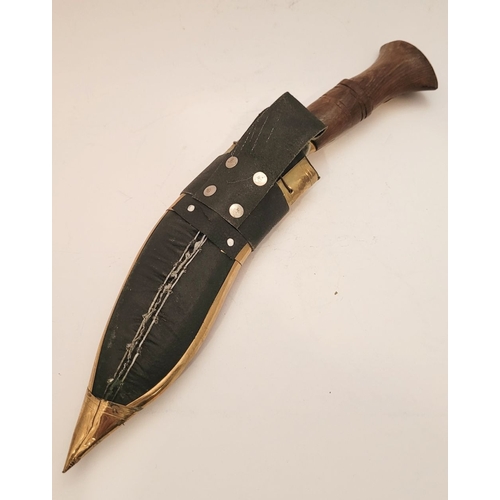 214 - A CONTEMPORY NEPALESE KUKRI GURKHA STYLE KNIFE, in sheath. The leather sheath with brass decorations... 