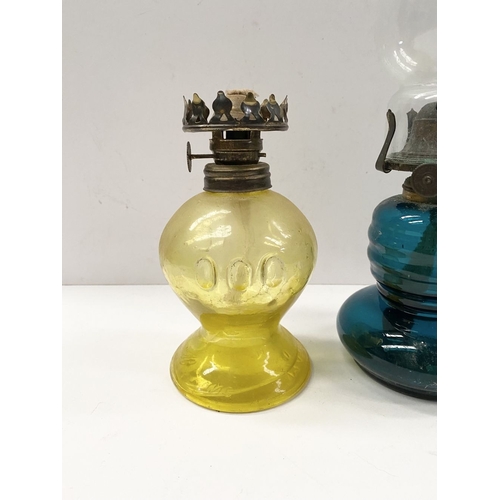 218 - TWO VINTAGE YELLOW & BLUE GLASS OIL LAMPS, (i) blue glass lamp reading ‘British Made’ to burner, com... 