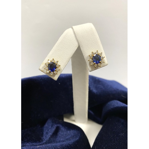 24 - A BEAUTIFUL PAIR OF SAPPHIRE & DIAMOND CLUSTER STUD EARRINGS, with central oval cut vibrant sapphire... 