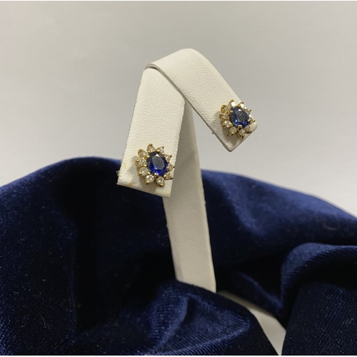 24 - A BEAUTIFUL PAIR OF SAPPHIRE & DIAMOND CLUSTER STUD EARRINGS, with central oval cut vibrant sapphire... 