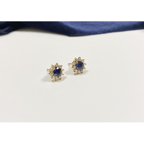 24 - A BEAUTIFUL PAIR OF SAPPHIRE & DIAMOND CLUSTER STUD EARRINGS, with central oval cut vibrant sapphire... 