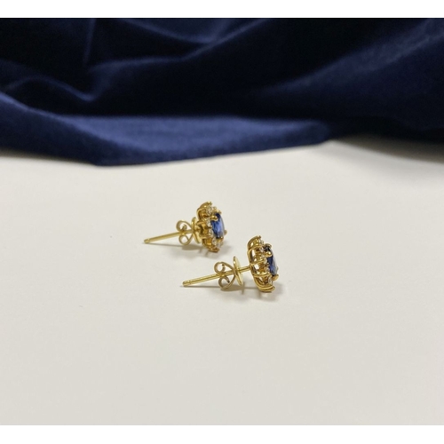 24 - A BEAUTIFUL PAIR OF SAPPHIRE & DIAMOND CLUSTER STUD EARRINGS, with central oval cut vibrant sapphire... 