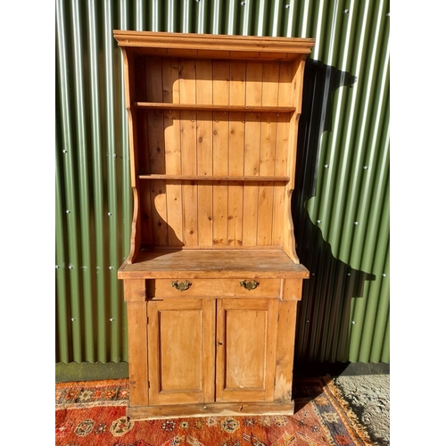 259 - A WELSH MADE ANTIQUE PINE DRESSER, with open shelves to top above base with one drawer over two door... 