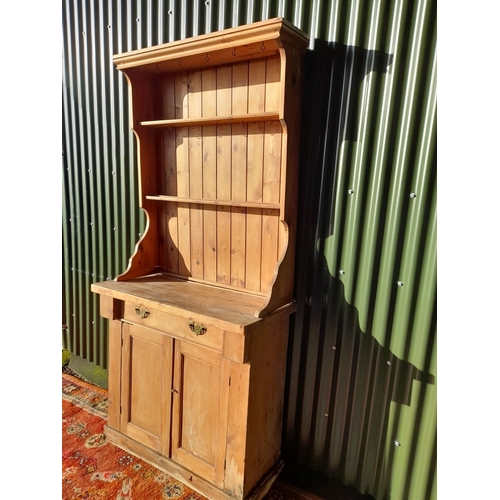 259 - A WELSH MADE ANTIQUE PINE DRESSER, with open shelves to top above base with one drawer over two door... 