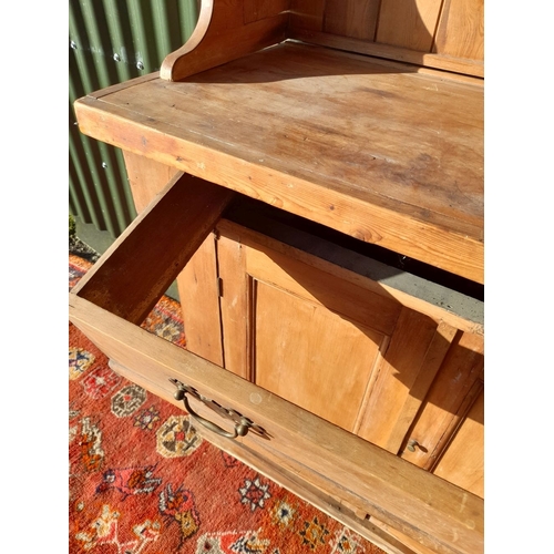 259 - A WELSH MADE ANTIQUE PINE DRESSER, with open shelves to top above base with one drawer over two door... 