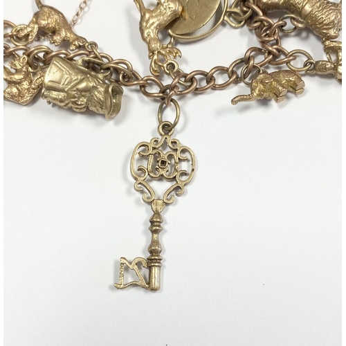 26 - A BEAUTIFUL 9CT YELLOW GOLD CHARM BRACELET, the chain is 9ct gold marked 375, with a wonderful array... 