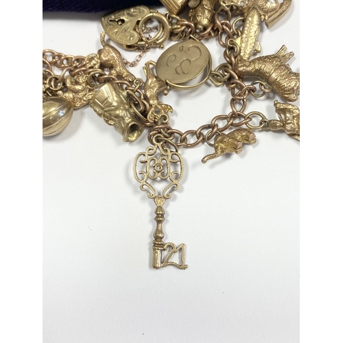 26 - A BEAUTIFUL 9CT YELLOW GOLD CHARM BRACELET, the chain is 9ct gold marked 375, with a wonderful array... 