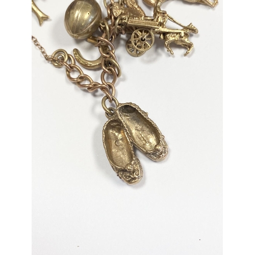 26 - A BEAUTIFUL 9CT YELLOW GOLD CHARM BRACELET, the chain is 9ct gold marked 375, with a wonderful array... 