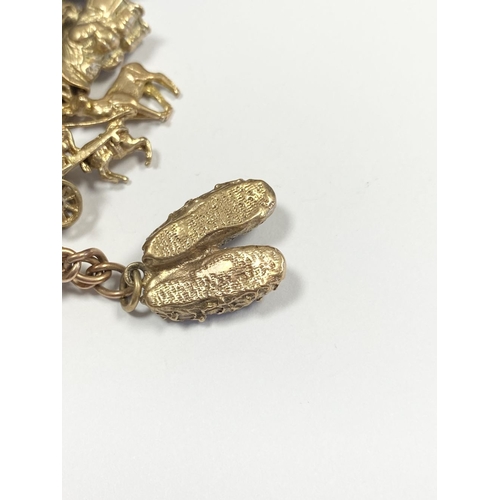 26 - A BEAUTIFUL 9CT YELLOW GOLD CHARM BRACELET, the chain is 9ct gold marked 375, with a wonderful array... 