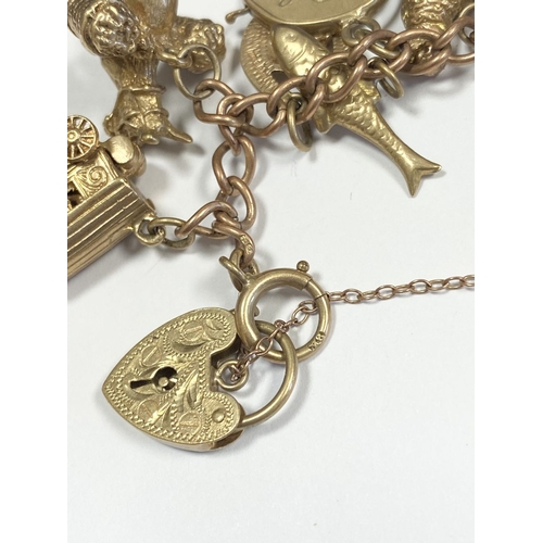 26 - A BEAUTIFUL 9CT YELLOW GOLD CHARM BRACELET, the chain is 9ct gold marked 375, with a wonderful array... 