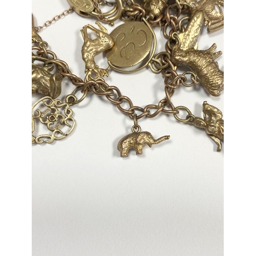 26 - A BEAUTIFUL 9CT YELLOW GOLD CHARM BRACELET, the chain is 9ct gold marked 375, with a wonderful array... 