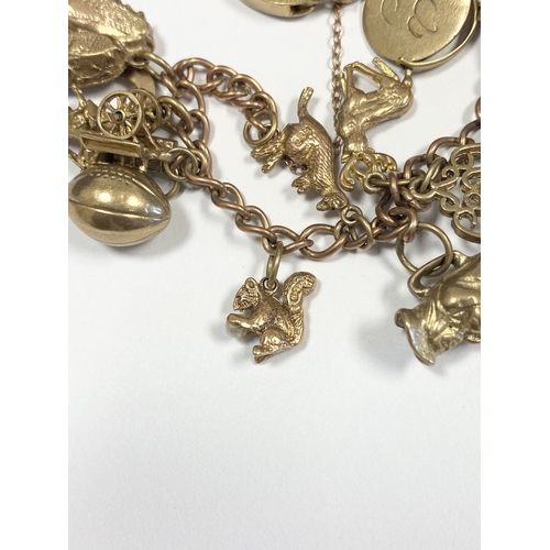 26 - A BEAUTIFUL 9CT YELLOW GOLD CHARM BRACELET, the chain is 9ct gold marked 375, with a wonderful array... 