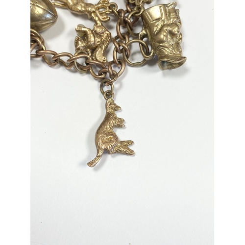 26 - A BEAUTIFUL 9CT YELLOW GOLD CHARM BRACELET, the chain is 9ct gold marked 375, with a wonderful array... 