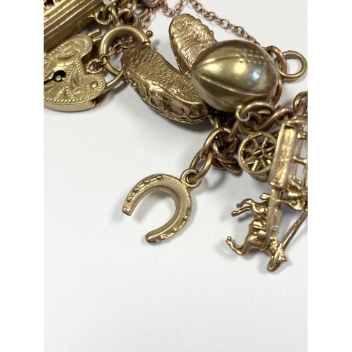 26 - A BEAUTIFUL 9CT YELLOW GOLD CHARM BRACELET, the chain is 9ct gold marked 375, with a wonderful array... 