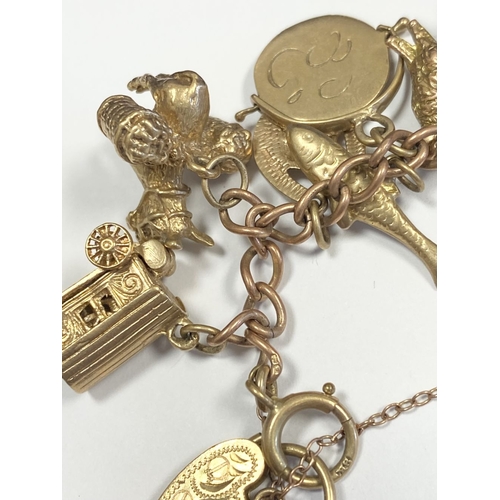 26 - A BEAUTIFUL 9CT YELLOW GOLD CHARM BRACELET, the chain is 9ct gold marked 375, with a wonderful array... 