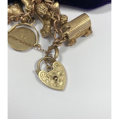 26 - A BEAUTIFUL 9CT YELLOW GOLD CHARM BRACELET, the chain is 9ct gold marked 375, with a wonderful array... 