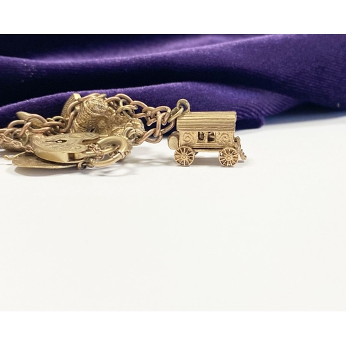 26 - A BEAUTIFUL 9CT YELLOW GOLD CHARM BRACELET, the chain is 9ct gold marked 375, with a wonderful array... 