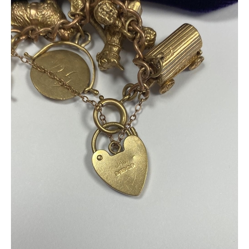 26 - A BEAUTIFUL 9CT YELLOW GOLD CHARM BRACELET, the chain is 9ct gold marked 375, with a wonderful array... 